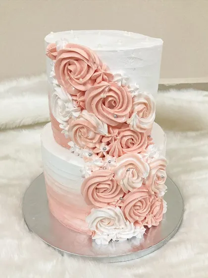This two-tier cake features a beautiful ombre effect with piped buttercream rosettes cascading down the side. It was a last-minute order that I was happy to accommodate for a wedding celebration.