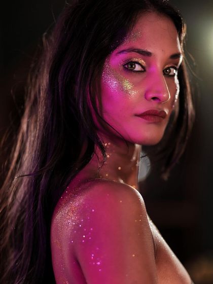 An intense and alluring close-up. The dramatic lighting and her direct gaze make this a powerful and unforgettable fine art portrait.