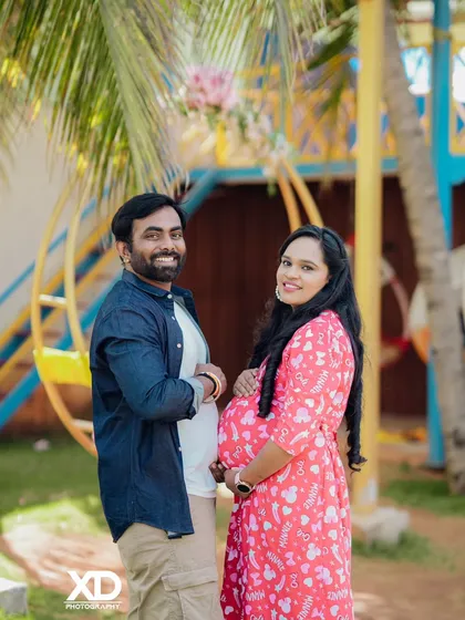 A happy and casual couple's portrait in a colorful outdoor setting.