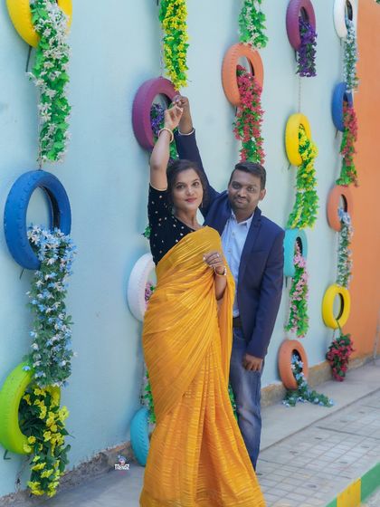 A fun and creative shot using a wall decorated with colorful tires. I love finding unique backdrops that reflect a couple's personality.
