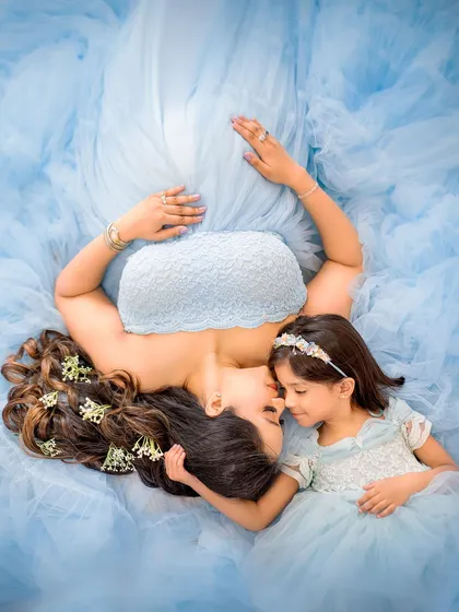 Creating unique and artistic portraits is a passion of mine. This aerial shot of a mother and daughter, enveloped in the flowing fabric of their matching blue dresses, tells a story of their beautiful connection in a visually stunning way.