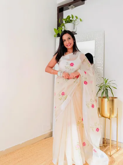 An off-white organza saree with beautiful rose embroidery. This is a very romantic and elegant saree, perfect for a special occasion.