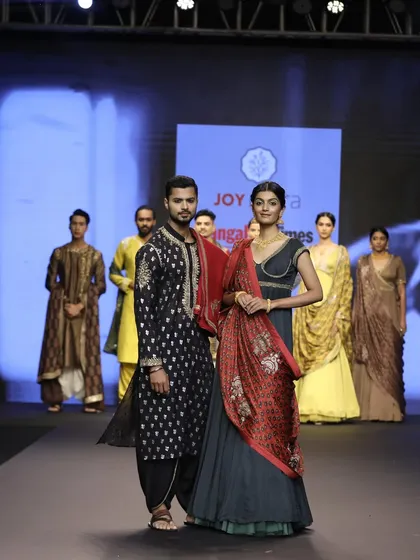 Posing with my co-model on the runway. This demonstrates my ability to work collaboratively to create a compelling visual story.