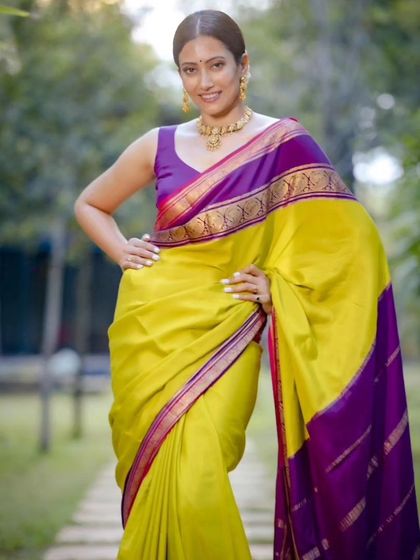 A close-up shot showcasing the vibrant colors of the pure Mysore crepe saree. The lime green and rich purple create a stunning visual contrast.