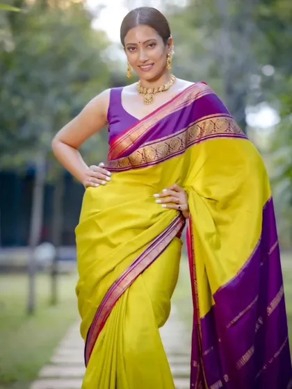 A close-up shot showcasing the vibrant colors of the pure Mysore crepe saree. The lime green and rich purple create a stunning visual contrast.