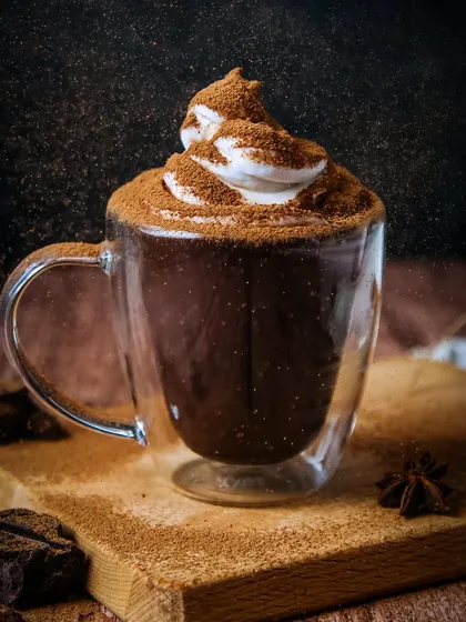 It's Hot Chocolate Season! A moody, dramatic shot of hot chocolate with a big swirl of whipped cream, showing a different stylistic approach.
