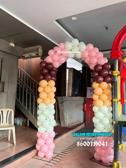 A simple and colorful balloon arch at the entrance of a party. The mix of pastel and bold colors is fun and inviting.
