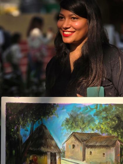 A proud artist with her completed plein air painting, a beautiful representation of the scenery from our outdoor class.