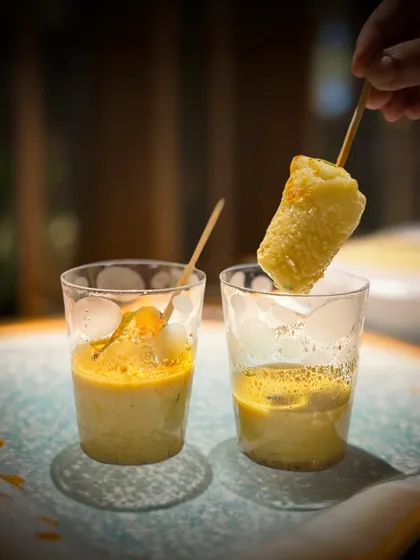 Meet my Kulfi Idli, a playful twist on a South Indian classic. I serve these soft, savory idlis on a stick, perfect for dipping into a luscious, creamy, and tangy sauce. It’s an interactive and surprising bite that always gets people talking.