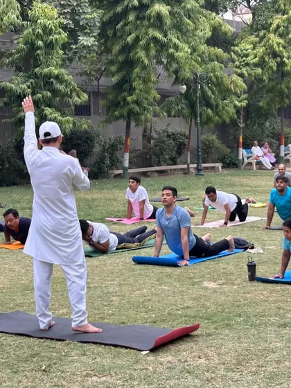 Leading a large outdoor class in Bhujangasana (Cobra Pose). Practicing in nature adds another layer of connection and tranquility to the yoga experience.