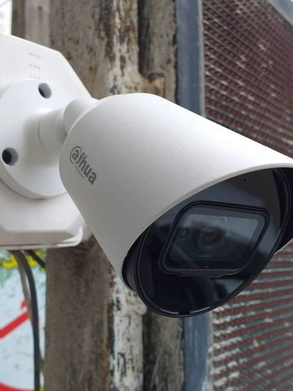 A close-up of a Dahua bullet camera mounted for outdoor surveillance. We select and install high-quality hardware that provides reliable performance for homes and businesses.