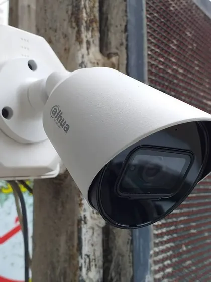 A Dahua bullet camera installed to monitor a storefront. The wide-angle lens and protective hood make it ideal for capturing activity in outdoor commercial environments.