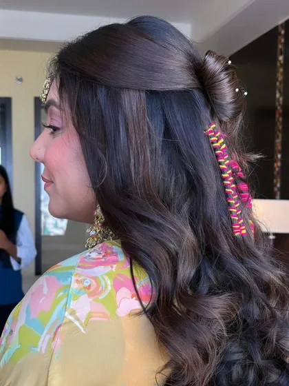 A side view of the hair bow and threaded braid style. It's a youthful and vibrant look, perfect for a fun-filled event.