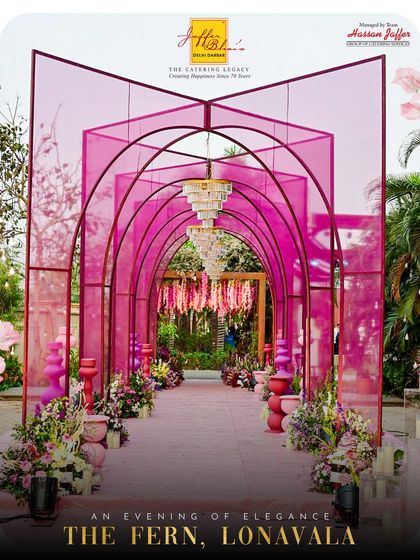 We bring our services to stunning locations like The Fern, Lonavala. This image shows the beautiful arched entryway of a wedding we catered, setting the tone for an evening of elegance.