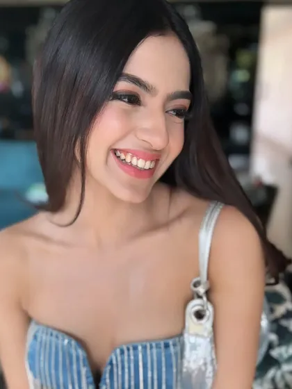 A beautiful, smiling close-up of Kashika. The makeup features a soft pink lip, rosy cheeks, and defined lashes to make her look radiant and camera-ready.