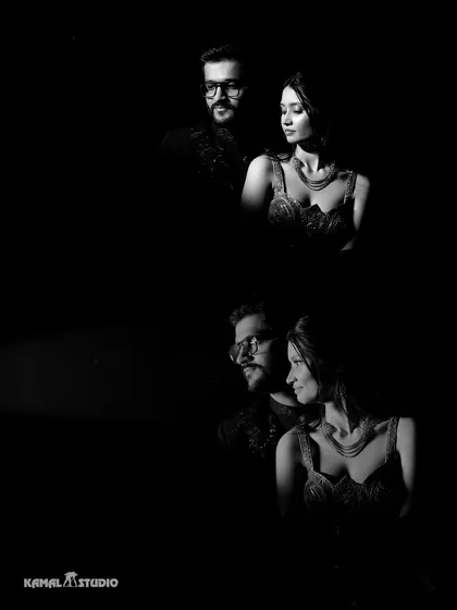 A moody and artistic black and white portrait of the couple. This dramatic lighting technique creates a sense of intimacy and high fashion.