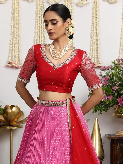 A close-up portrait that highlights the intricate embroidery on the blouse and the bride's joyful expression.
