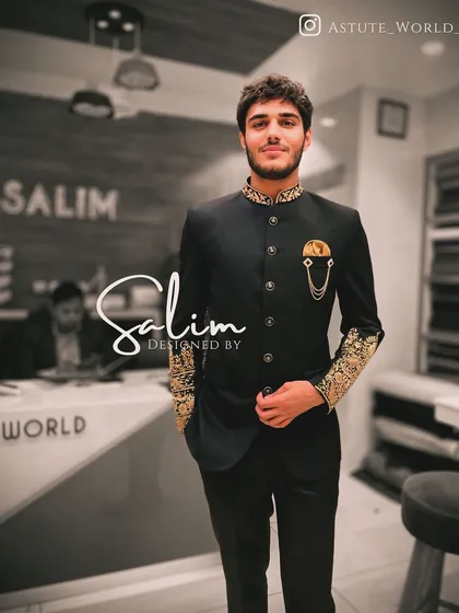 A client wearing a black Jodhpuri suit with gold embroidery on the collar and cuffs, plus a statement brooch. This is a classic, royal look for any grand celebration.