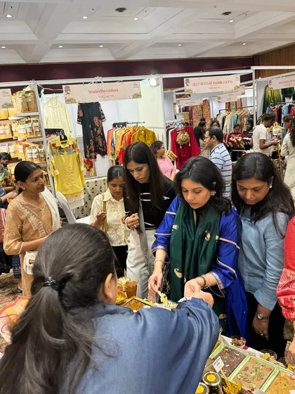 Another shot of me engaging with customers at my stall. Offering a taste of my creations is the best way for people to experience the quality and flavor I stand for.