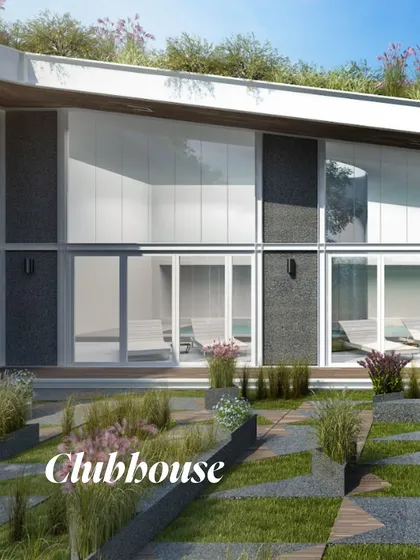 A render of the clubhouse, showcasing its integration with the landscape. The design features a green roof and large glass panels, blurring the lines between indoor and outdoor recreational spaces.