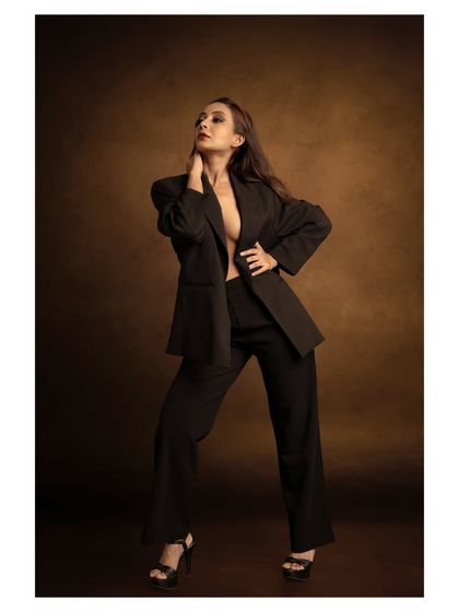 A powerful fashion statement with a classic power suit. I used a warm, painterly backdrop to contrast with the sharp, modern tailoring, creating a look suitable for a magazine editorial.