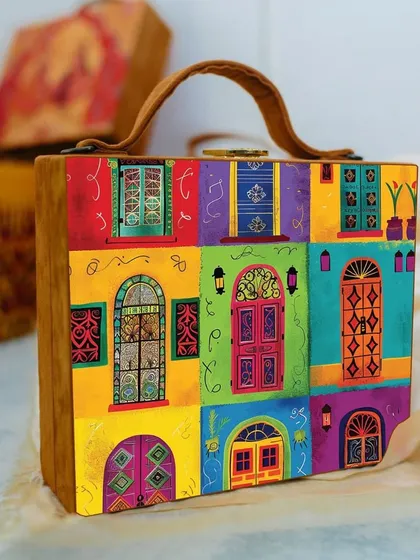 This colorful bag, printed with a variety of vibrant Indian doors and windows, is perfect for adding a quirky and artistic touch to your look. It comes with both a handle and a sling for versatility.
