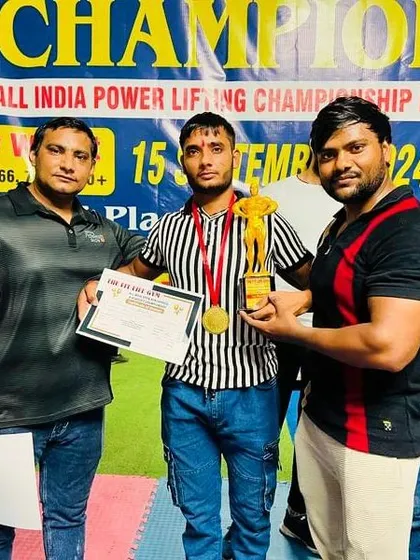 The result of hard work is not just strength, it is victory. I am proud to stand with my student, a champion holding his trophy. This is what we train for: to go from the gym floor to the winner's podium.