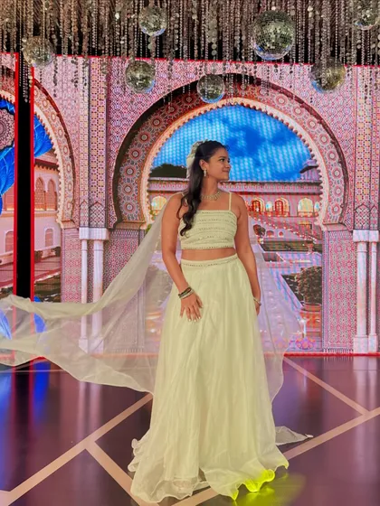 Another angle of my ethereal white outfit for the Sangeet, with the cape flowing against the beautifully lit stage.