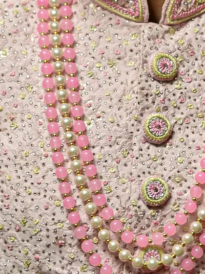 Another detailed shot of the intricate craftsmanship on this premium pink sherwani.