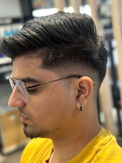 A three-quarter view of the men's fade, highlighting the volume and texture on top.