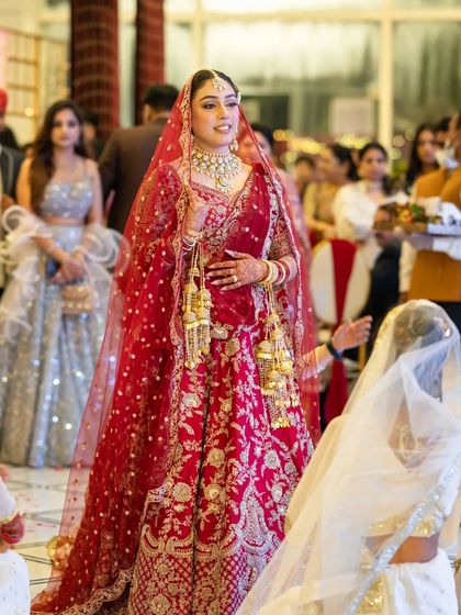 A candid shot of the bride walking down the aisle, her expression full of anticipation and happiness.