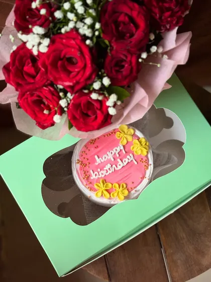 The perfect classic gift: a pretty pink floral birthday bento cake paired with a stunning bouquet of fresh red roses. It’s a simple and elegant way to make someone's day special.