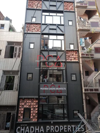 The Chadha Properties office building, showing multiple floors and the integration of our firm's branding into the facade design.