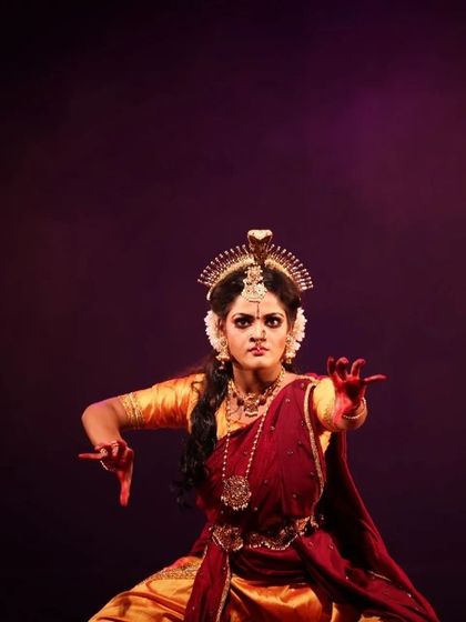 A solo performer captured in a moment of intense expression during "Shrishti Stithi Laya". The dramatic lighting and powerful posture convey the raw emotion of the story.