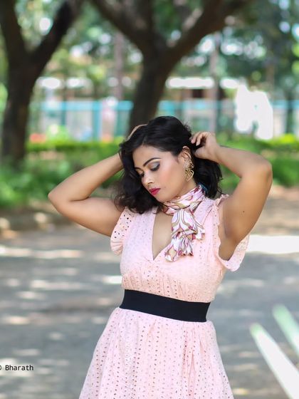 A candid moment captured in a park. The natural light and relaxed pose create an authentic and engaging lifestyle photo.