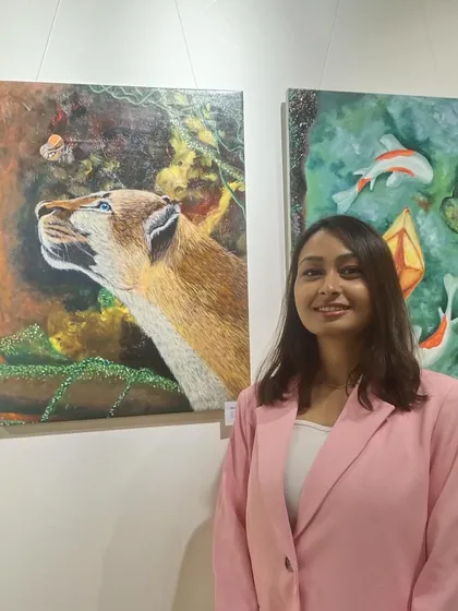 Here I am at my first art exhibition, standing next to a couple of my creations. Being able to share my work and connect with people who appreciate art is an incredible experience that fuels my passion.