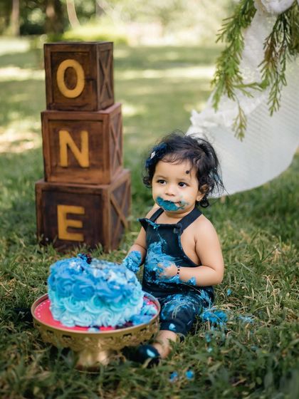 A duplicate of image 36, showing the full outdoor cake smash scene.