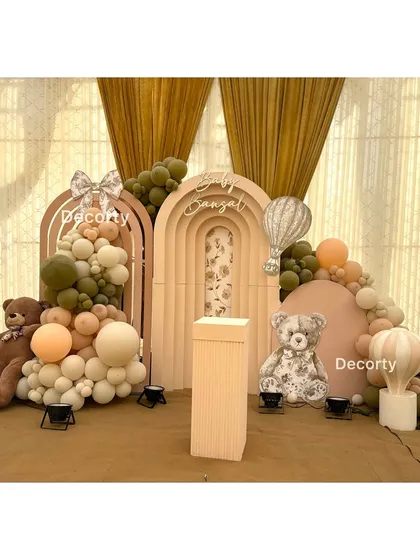The main backdrop for the rustic teddy bear party, featuring arched panels, a floral-patterned teddy, and earthy-toned balloons.