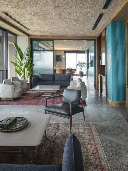The lounge areas at Primarc borrow the comfort of home. We used earthy materials like polished concrete and recycled wood, paired with comfortable furniture and textured rugs, to create a serene environment that helps reduce stress.