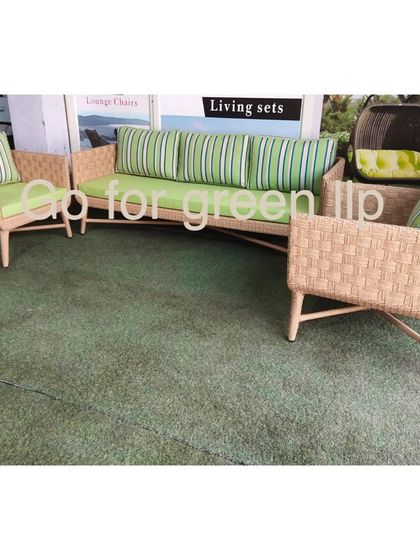 This living set combines a light-colored wicker frame with vibrant green striped cushions for a fresh, summery feel. It’s a perfect example of how we use color to create unique, luxury outdoor furniture that stands out.