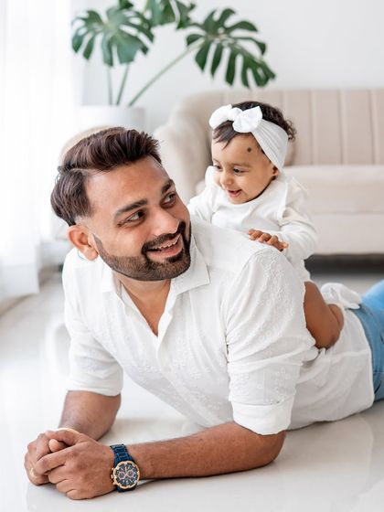 A father and daughter playing together on the floor.