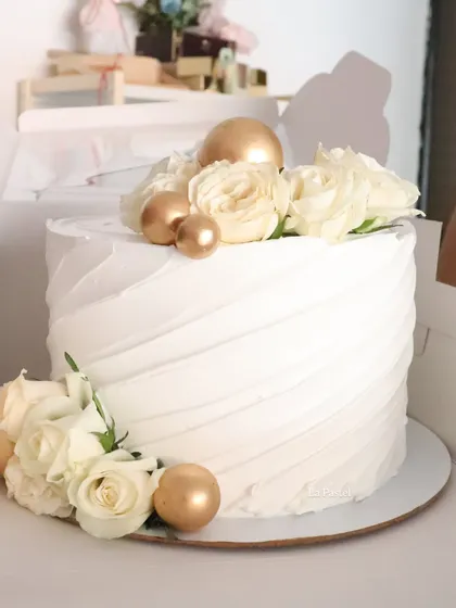 Another look at this pretty white and gold cake, ready to be boxed up for a special celebration.