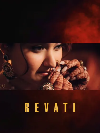 A close-up of Revati adjusting her nose ring, a classic bridal moment. The focus is on her expressive eyes and the intricate henna on her hands.