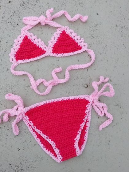 One of my first baby bikini designs. This simple and sweet two-piece set in bright pink and red is fully adjustable with side ties, ensuring a comfortable fit for a fun day of photos.