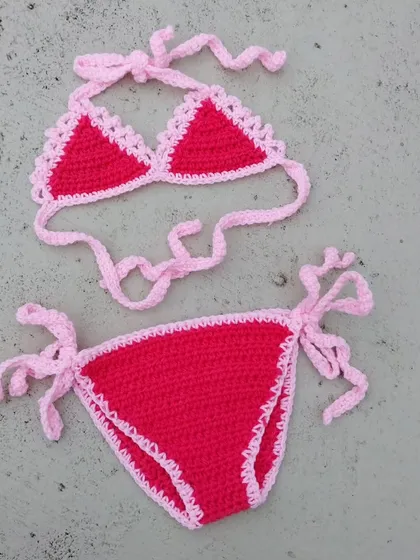 One of my first baby bikini designs. This simple and sweet two-piece set in bright pink and red is fully adjustable with side ties, ensuring a comfortable fit for a fun day of photos.
