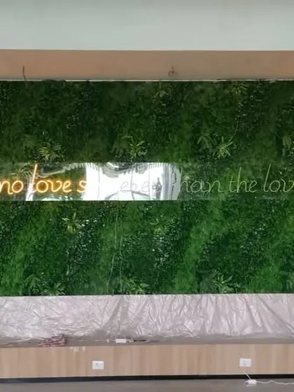We installed this large artificial green wall as a backdrop in a restaurant, featuring a neon quote about food. It creates a fantastic feature wall and a popular spot for photos.