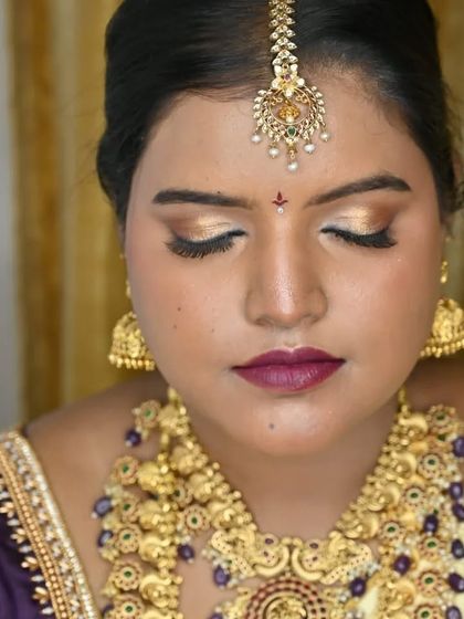 A close-up of the finished eye makeup. The metallic gold shadow and perfectly defined lashes create a look of pure bridal glamour.