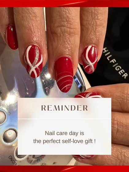A bold and festive nail art design. This set features a vibrant red base with intricate white and silver glitter swirls, making it perfect for holidays or celebrations.