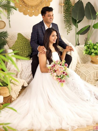 A candid moment from a family session, with the couple sharing a happy look. The mother's beautiful white gown and bouquet add a touch of elegance.