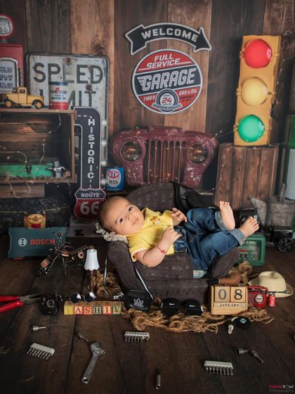 Wide awake and ready for work! Even when babies are awake, I can capture wonderful moments within my themed setups, like this little mechanic looking right at the camera.